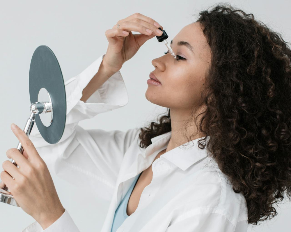 Woman applying skin care oils