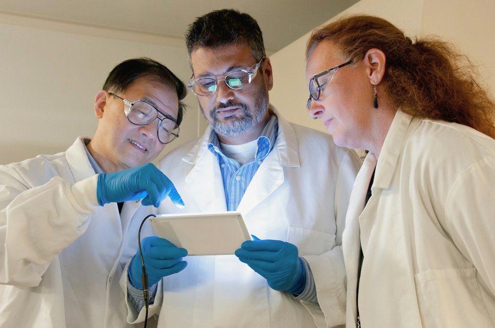Three medical colleagues comparing notes