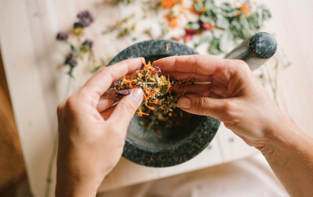 mixing herbs by hand