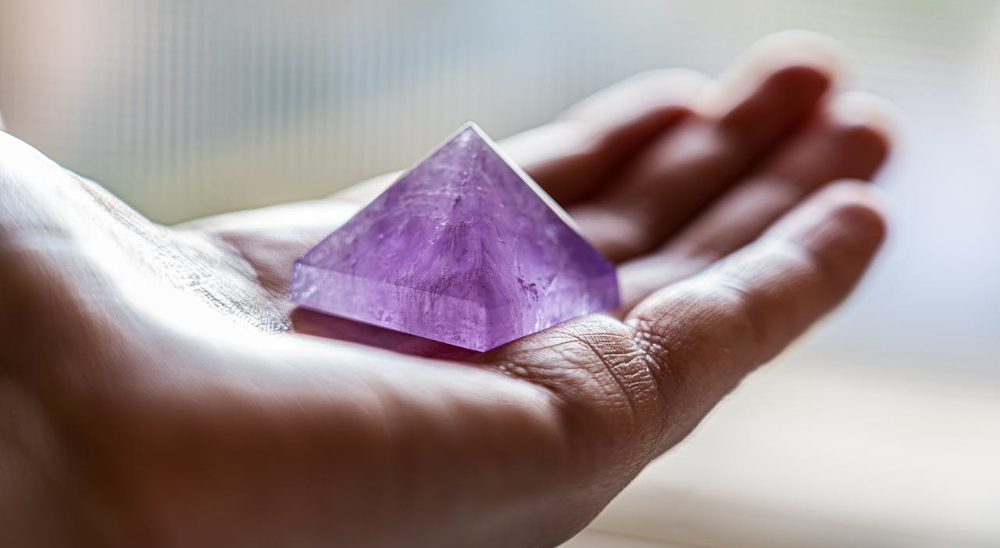 Amethyst shaped like a pyramid in hand