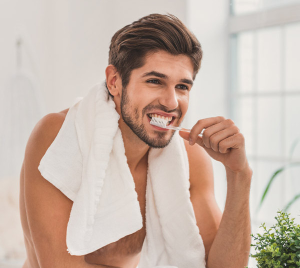 The Health Connection Between Your Mouth And Body_man brushing teeth