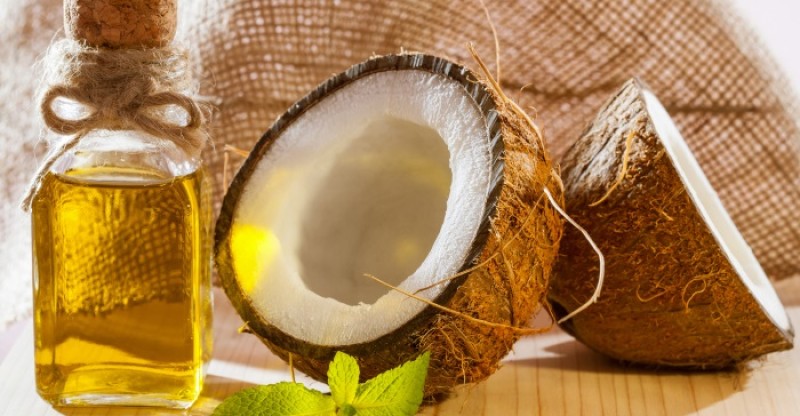 Is Coconut Oil Unhealthy?_coconuts and oil on a table