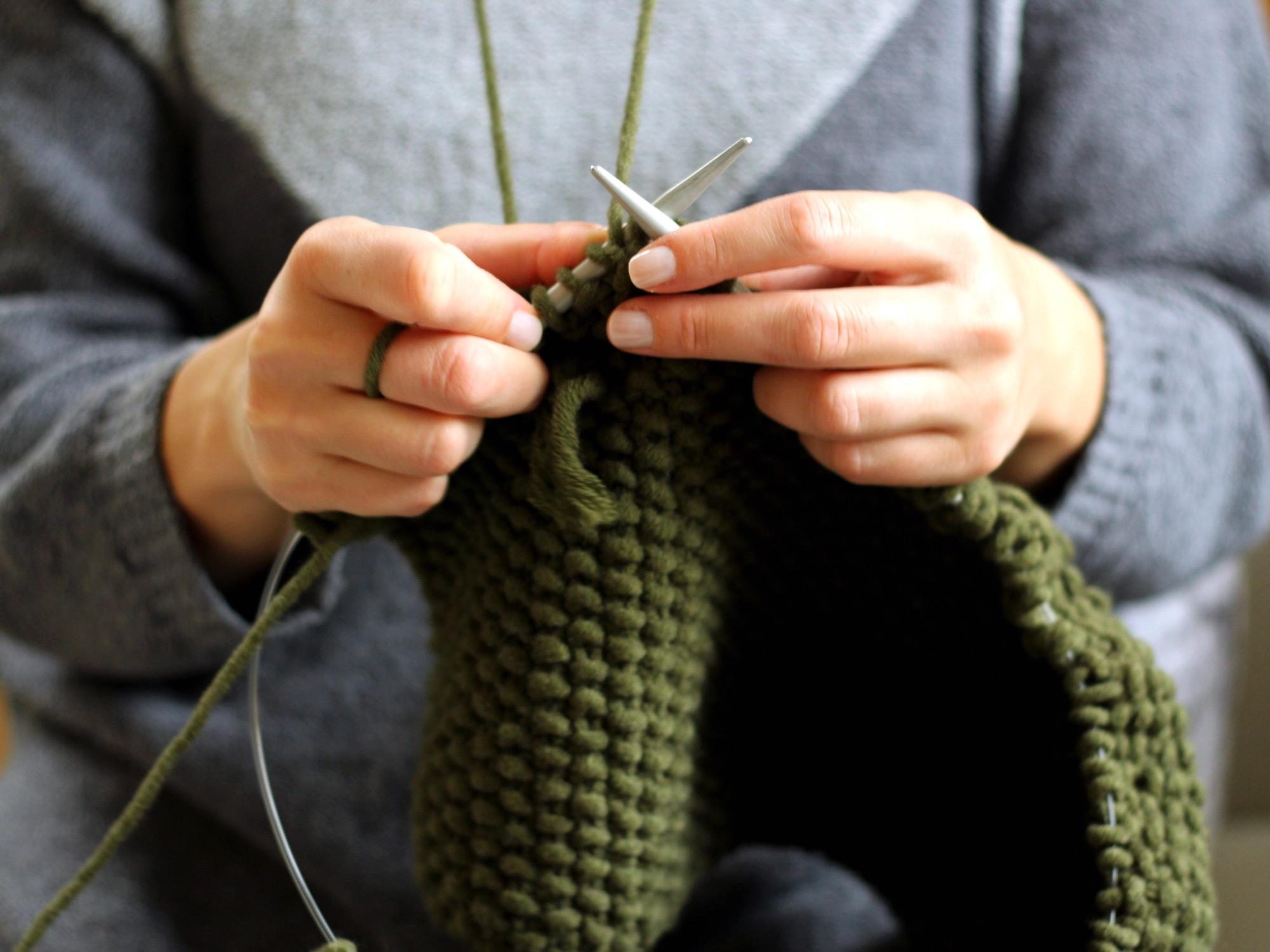 Close-Up Of Woman Hands Knitting